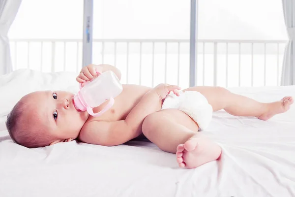 Close Cute Baby Girl Drinking Milk Bottle While Lying Bed — Stock Photo, Image