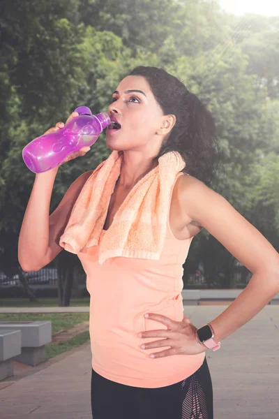 Indian Young Woman Drinking Water Bottle Workout While Standing Park — Stock Photo, Image