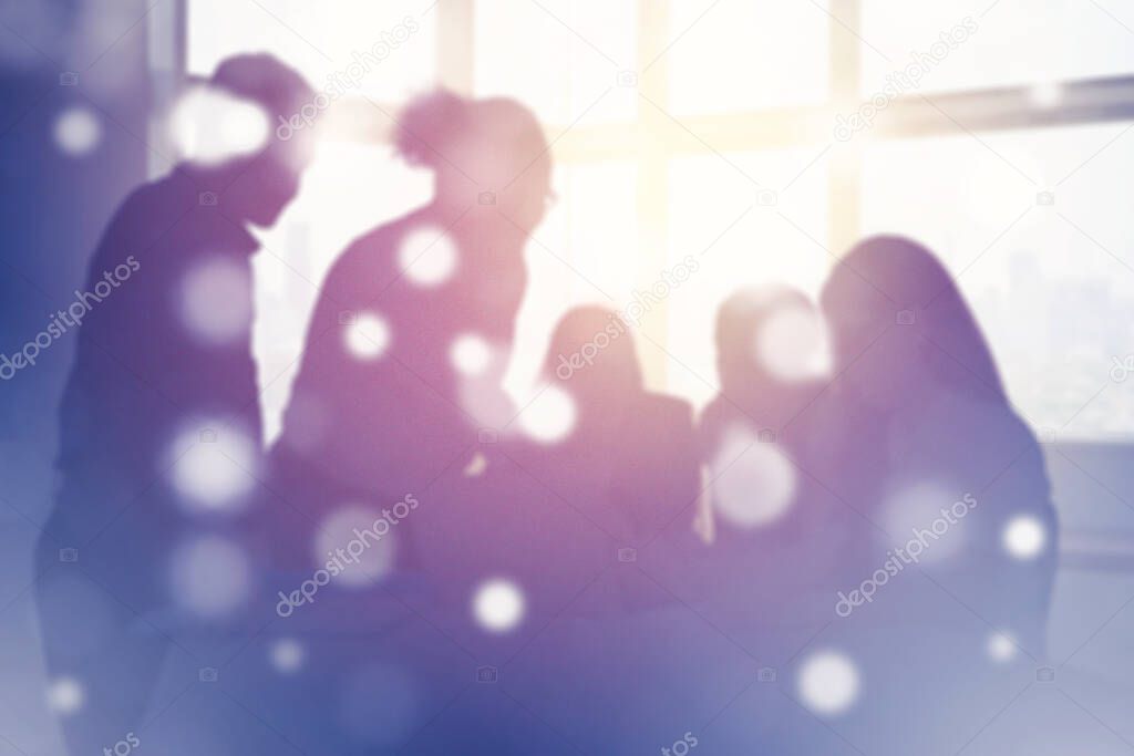Silhouette of business team is meeting in the office while discussing near the window with double exposure of blurred sparkling lights