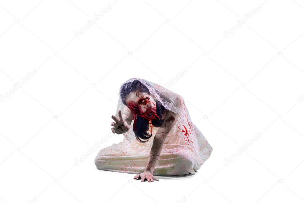 Halloween horror concept. Horrible female bride reach out her hand at the camera while crawling in the studio. Isolated on white background