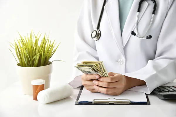 Hospital and medical expense, Doctor holding banknote money, Health insurance concept.