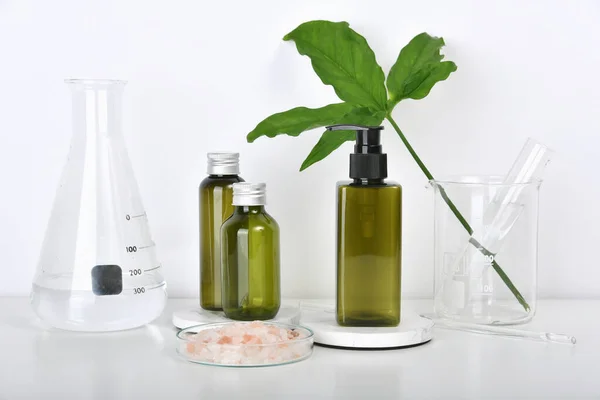 Natural skincare beauty products researching lab, Natural organic botany extraction and scientific laboratory glassware, Blank label cosmetic container for branding mock-up.