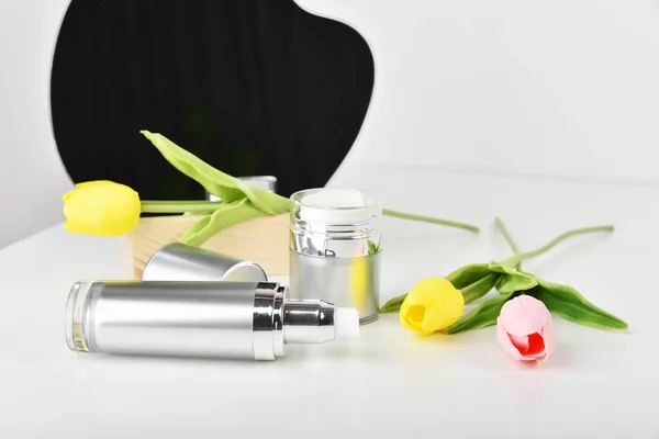 Natural skincare pump bottle, Cosmetic bottle containers packaging with tulip flower essence, Organic beauty product concept.