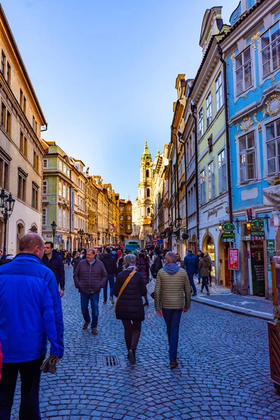 PRAGUE, CZECH REPUBLIC - 1.12.2018: Prague old city town center. City street with tourist, shops, cafee, restaurants. Ancient historical buildings in Czech capital. European travel in bohemia