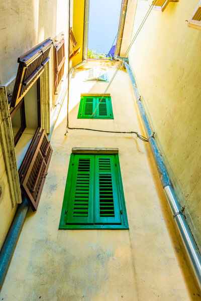 Old and narrow streets in Piran city, Slovenia. Ancient medieval streets in town center of famous European city, near the adriatic sea. Old houses with wooden windows and doors, magical atmosphere