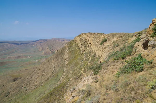 stock image Cave monasteries. Path on the rock edge, on the half-desert slopes of Mount Gareja. David Gareja is a rock-hewn Georgian Orthodox monastery complex. Kakheti region, on border of Georgia and Azerbaijan