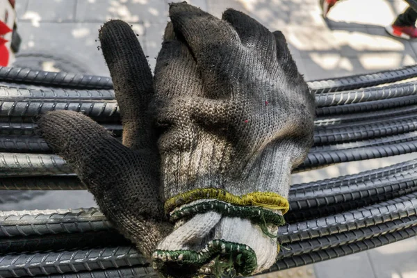 Old glove on steel bar