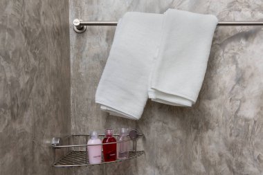 White towels with soap on a rack in the bathroom.