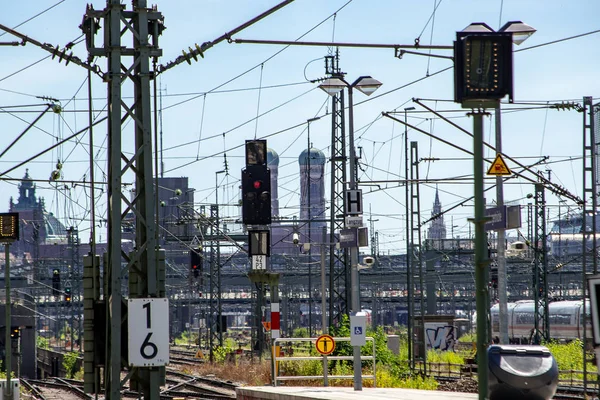 View of rail  yard in Munich, Germany with city landmarks in  the background