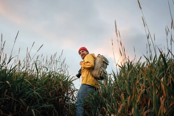 Young Traveler Wearing Backpack Yellow Raincoat Hiking High Grass Hipster — Stock Photo, Image