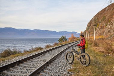 Turist Baykal Gölü Kıyı boyunca geniş tekerlekli bisiklet sürmek.