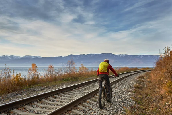 Turist Baykal Gölü Kıyı boyunca geniş tekerlekli bisiklet sürmek.