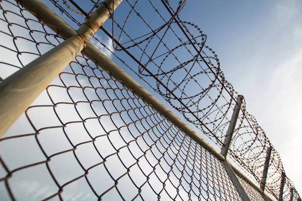 Metal fence wire, War and sky in the background in Phuket Thailand