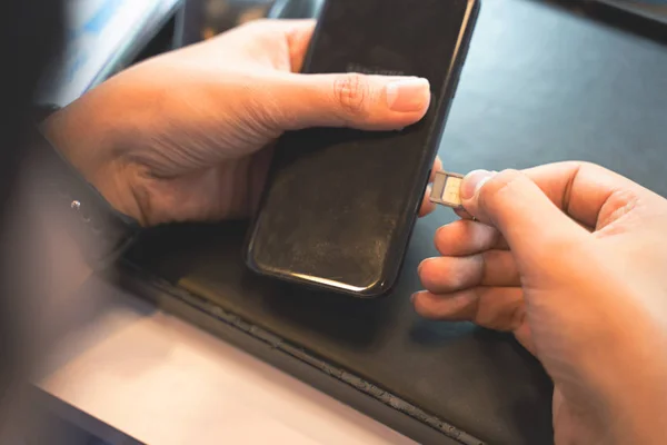 Employees are putting nano SIM cards in the store for customers to buy,Man\'s hand.