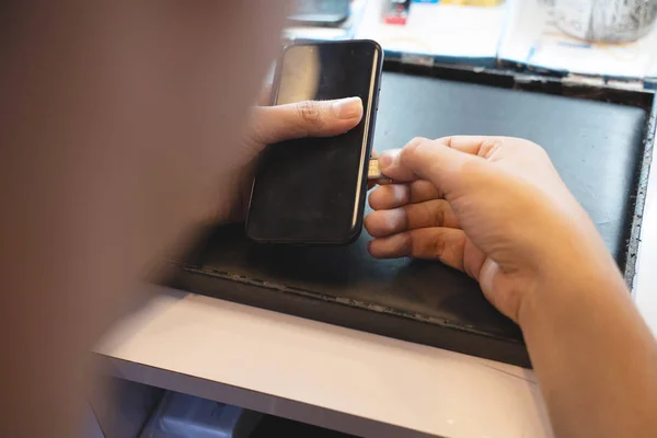 Employees are putting nano SIM cards in the store for customers to buy,Man\'s hand.