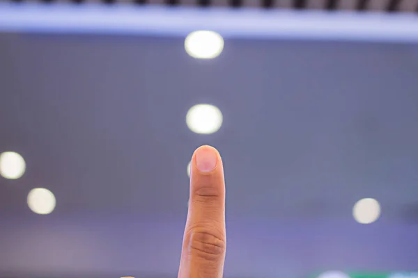 Index finger, men 26 years old, bokeh background