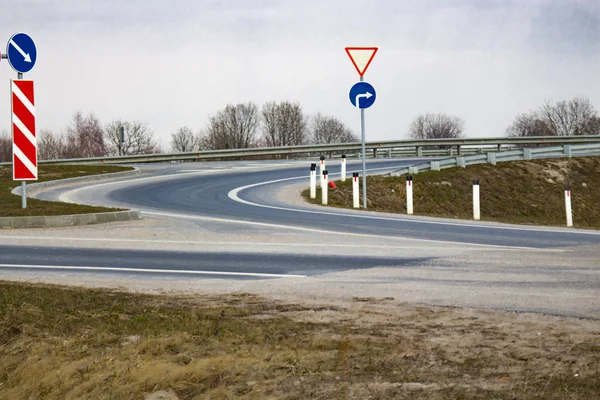 road junction with turn and road signs