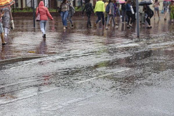 Russia Kaliningrad 2019 people run down the street in the rain