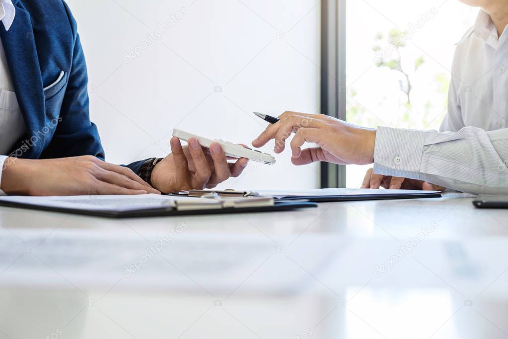 Businessman being analysis and making the decision a car insurance policy, Agent man is holding the calculator and waiting for his reply to finish.