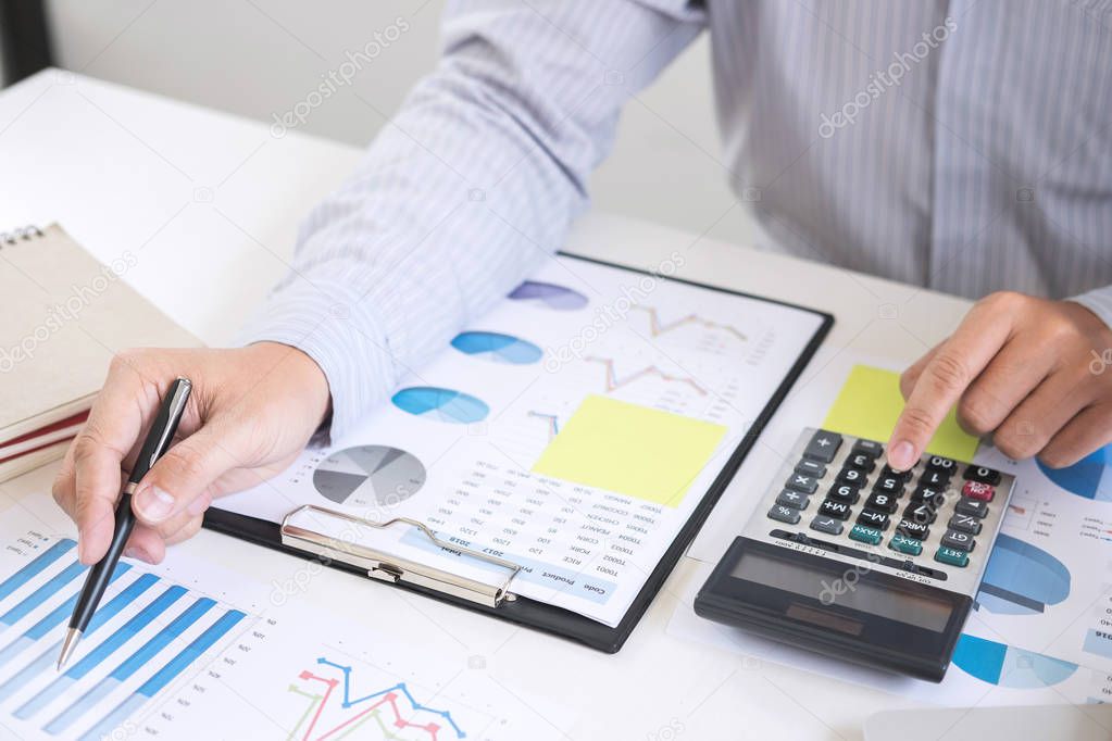 Business accountant or banker, businessman calculate and analysis with stock financial indices and financial costs wisely and carefully, investment and saving concept.