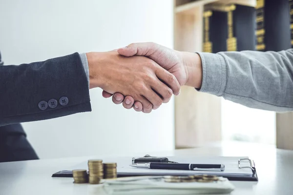 Handshake of cooperation customer and salesman after agreement, successful car loan contract buying or selling new vehicle.