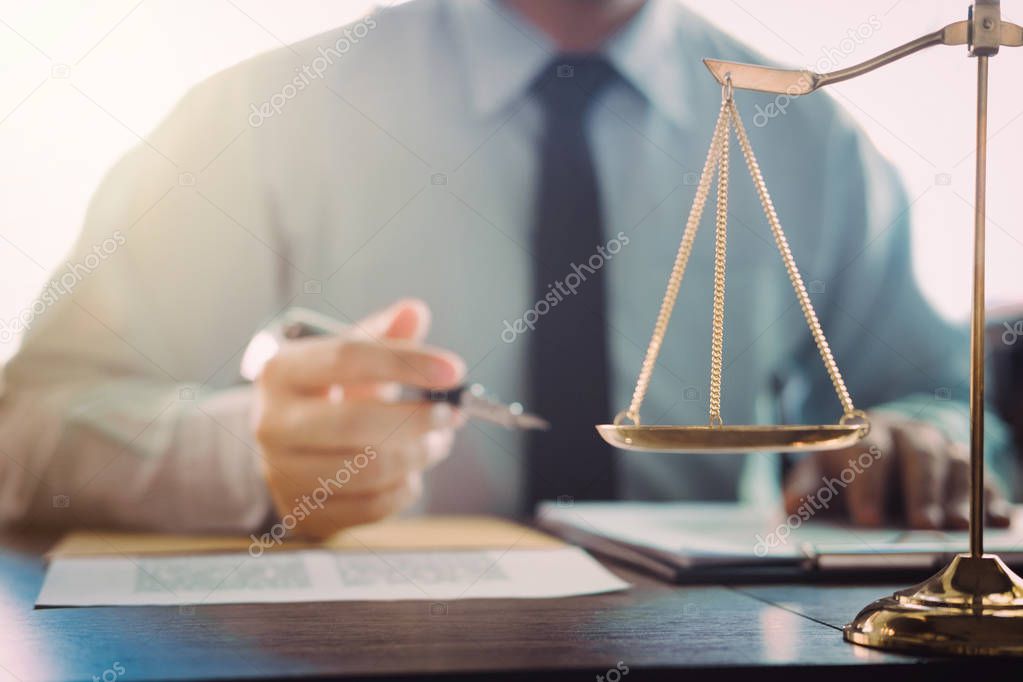 Judge gavel with Justice lawyers, Businessman in suit or lawyer working on a documents in courtroom. Legal law, advice and justice concept.