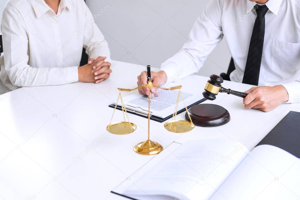 Businesspeople or lawyer having team meeting discussing agreement contract documents, judge gavel with Justice lawyers at law firm in background, Legal law, advice and justice concept.
