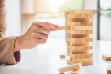 Alternatif risk planı ve strateji büyüme için iş, ahşap oyun, executive sipariş ahşap blok kule üzerinde eller genç akıllı iş kadını kar.