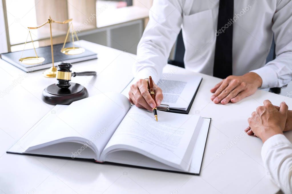 Businesspeople or lawyer having team meeting discussing agreement contract documents, judge gavel with Justice lawyers at law firm in background, Legal law, advice and justice concept.