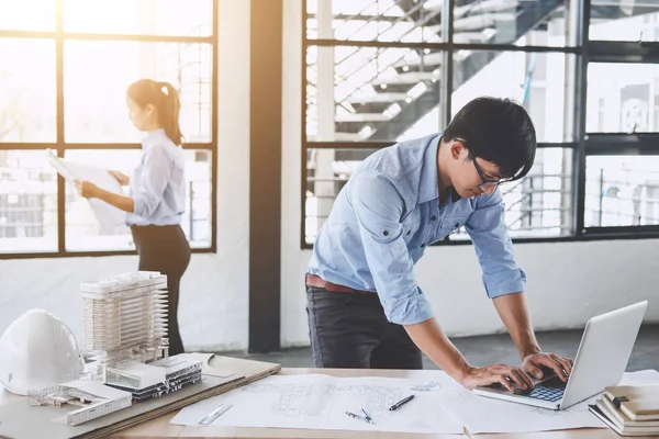 Mimar veya bina ve araçlar çalışma sitesi, inşaat kavramı içinde mühendislik modeli ortak çalışma projesi için Toplantı planı üzerinde çalışan mühendis.