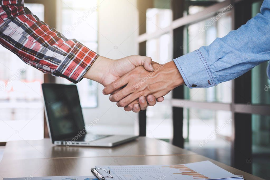 Teamwork of business partnership Handshaking after good cooperation, Consultation between businessman and customer, Trading contract and new projects for the company, Meeting and greeting concept.