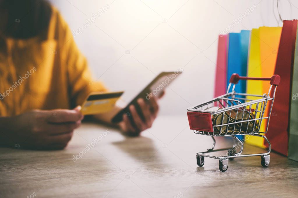 Image of Young woman using smartphone for online shopping website and pay by credit card, Online payment and shopping concept.