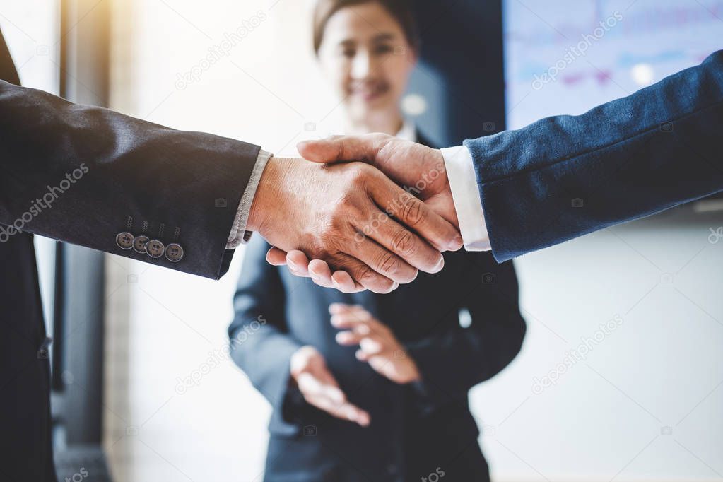 Finishing up a meeting, Business handshake after discussing good deal of Trading to sign agreement and become a business partner, contract for both companies, Successful businessman handshake.