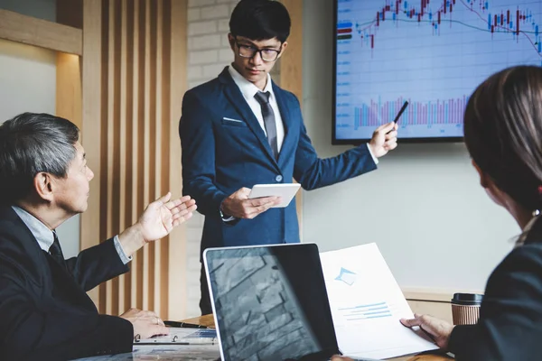 Business people are working in office, presentation in front of boss, businessman leader presentation to colleagues and business strategy and pointing to the graph and chart.