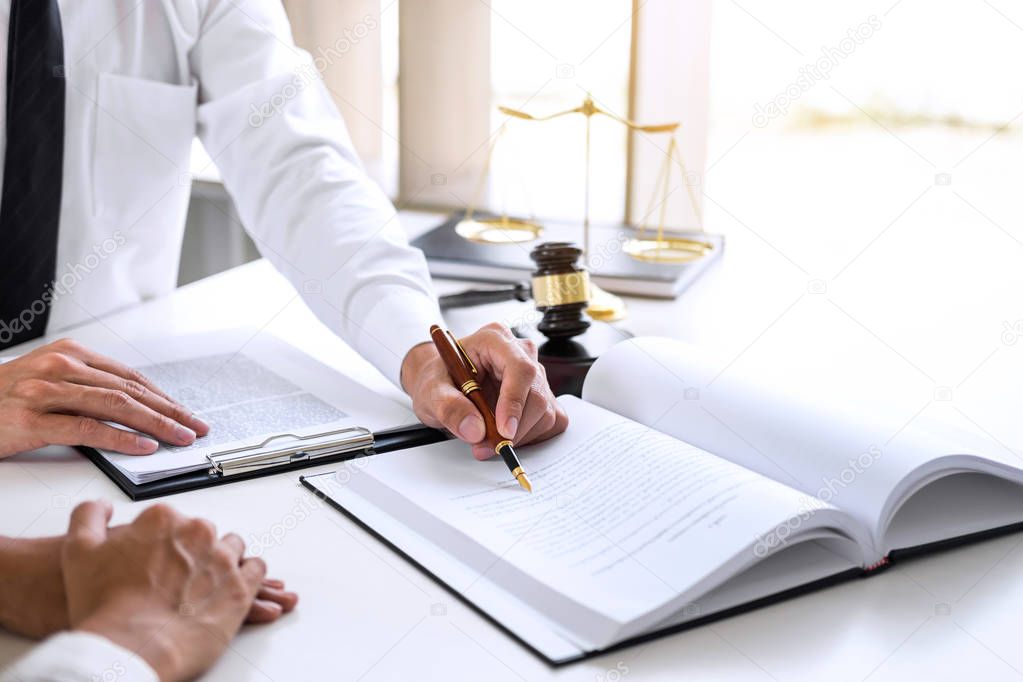 Businesspeople or lawyer having team meeting discussing agreement contract documents, judge gavel with Justice lawyers at law firm in background, Legal law, advice and justice concept.