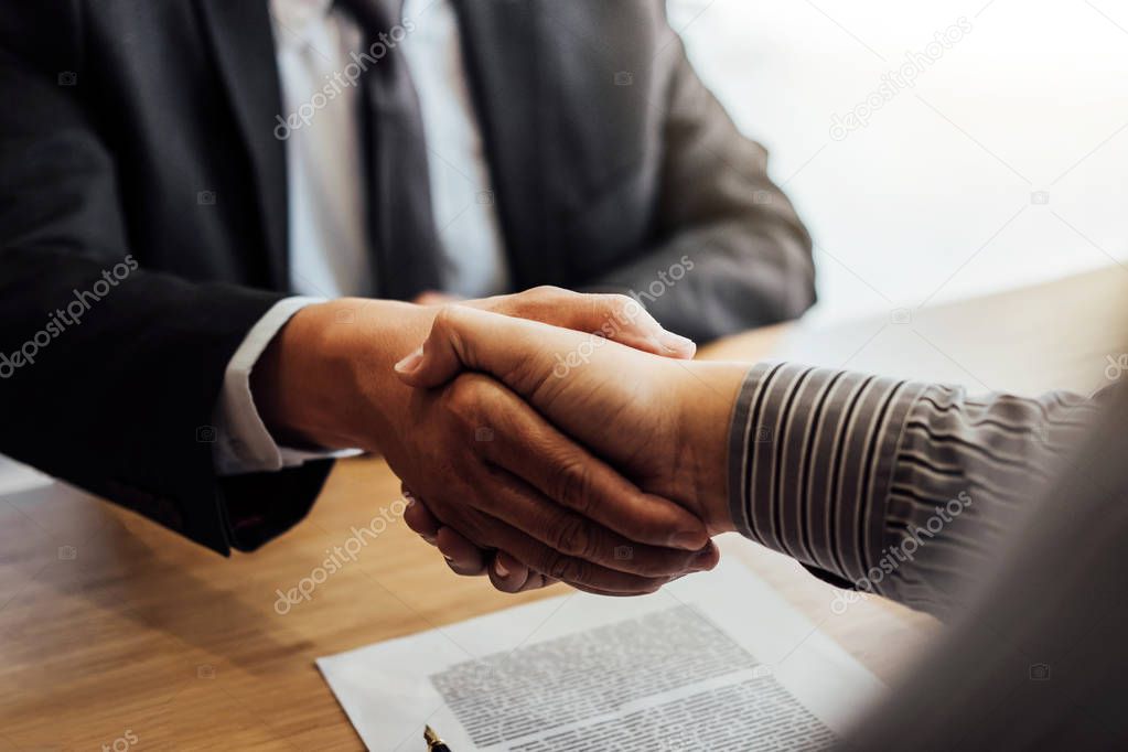 Shaking hands after good cooperation, Businessman handshake male lawyer after discussing good deal of contract, Meeting and collaboration concept.