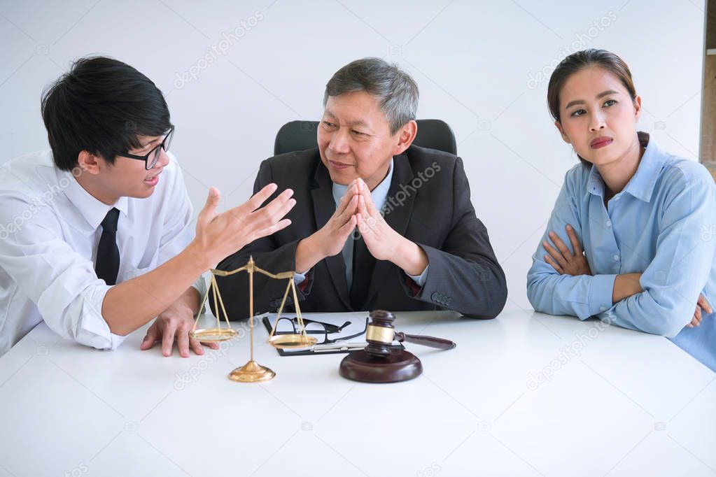 Unhappy divorce couple having conflict, Man and wife conversation during divorce process with senior male lawyer or counselor.