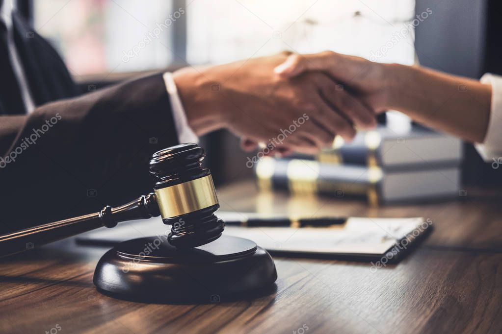 Good service cooperation of Consultation between a male lawyer and business woman customer, Handshake after good deal agreement, Law and Legal concept.