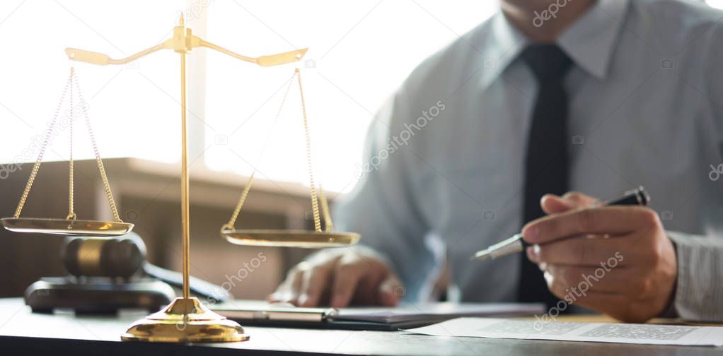 Judge gavel with Justice lawyers, Businessman in suit or lawyer working on a documents in courtroom. Legal law, advice and justice concept.