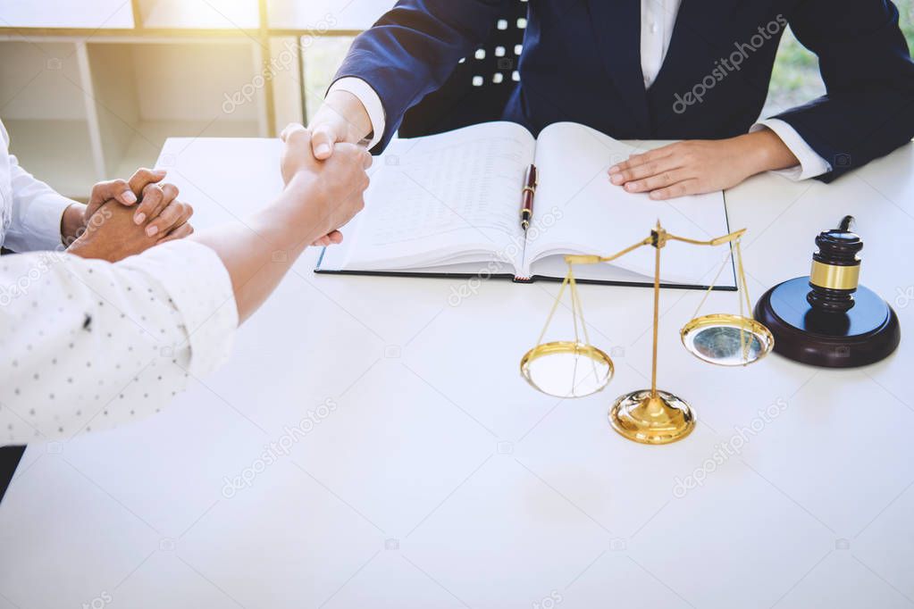 Handshake after good cooperation greeting, Having meeting with team at law firm, Consultation between a female lawyer and businessman customer, tax and the company of real estate concept.