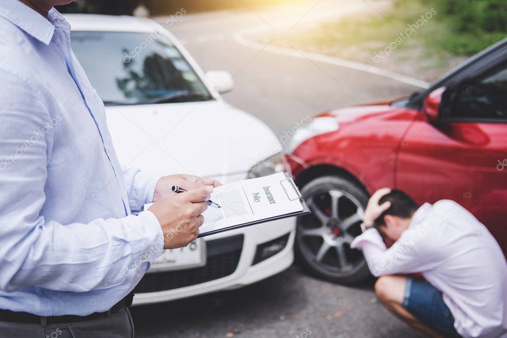 Traffic Accident and insurance concept, Insurance agent working on report form with car accident claim process.