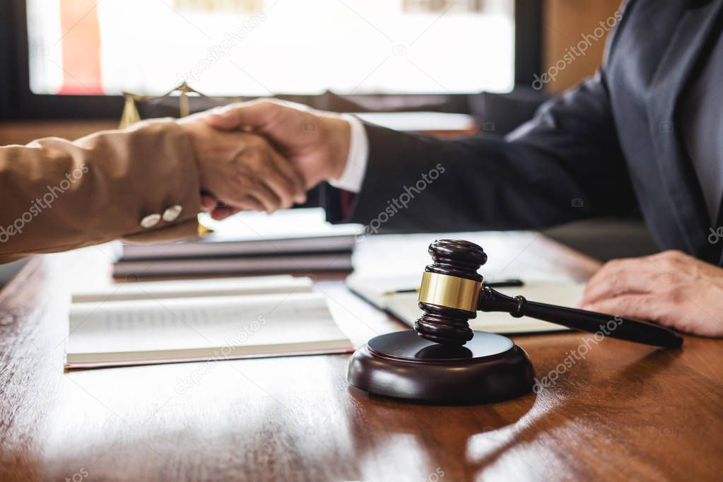 Good service cooperation of Consultation between counselor or male lawyer and business woman customer, Handshake after good deal agreement, Law and Legal concept.