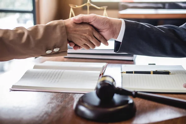 Good service cooperation of Consultation between counselor or male lawyer and business woman customer, Handshake after good deal agreement, Law and Legal concept.