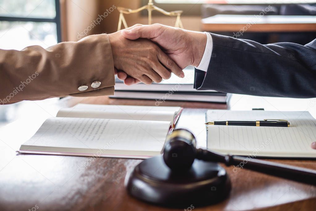 Good service cooperation of Consultation between counselor or male lawyer and business woman customer, Handshake after good deal agreement, Law and Legal concept.