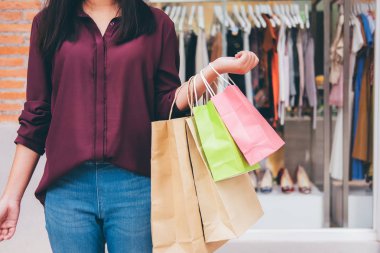 Tüketim, yaşam kavramı, ayakta ve renkli alışveriş torbaları alışveriş zevk tutan genç kadın alışveriş.