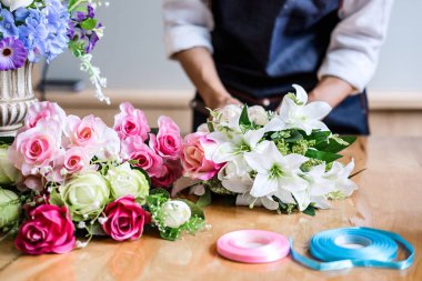 Yapay çiçek yeleği dekorasyon evde düzenlenmesi, Genç kadın çiçekçi iş DIY yapay çiçek, el sanatları ve el yapımı kavramı düzenleme yapma.