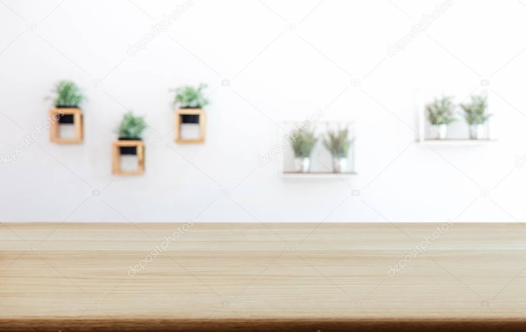 Empty wooden table and blurred background of abstract in front of coffee shop or restaurant for display of product or for montage.