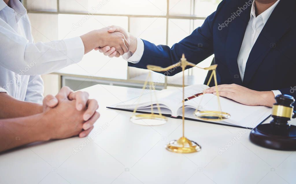 Handshake after good cooperation greeting, Having meeting with team at law firm, Consultation between a female lawyer and businesswoman customer, tax and the company of real estate concept.