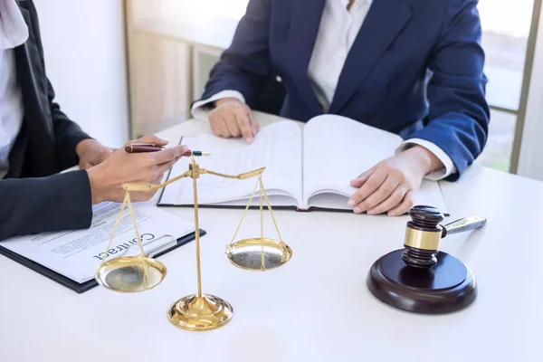 Teamwork of business lawyer colleagues, consultation and conference of professional female lawyers working having at law firm in office. Concepts of law, Judge gavel with scales of justice.