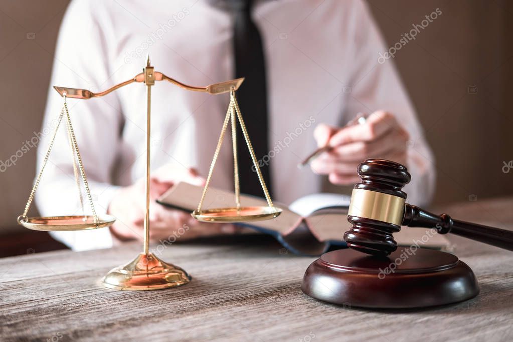 Judge gavel with scales of justice, male lawyers working having at law firm in office. Concepts of law advice and justice.